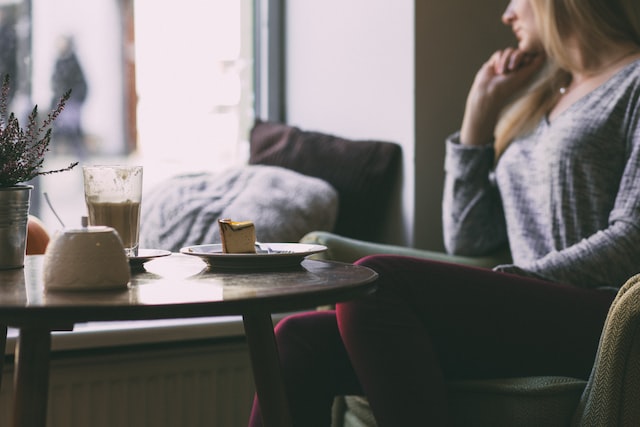 woman in a coffee shop staring out the window