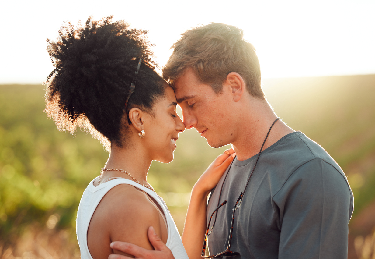 couple nose to nose in a field