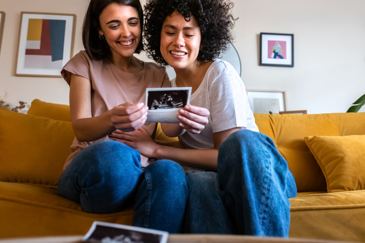 lesbian couple looking at a sonogram