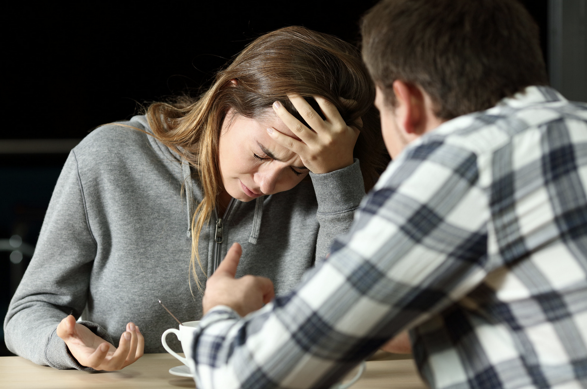 woman in a distressing conversation with her husband