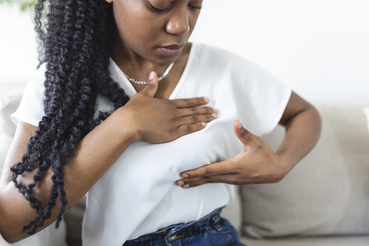 woman giving herself a breast exam