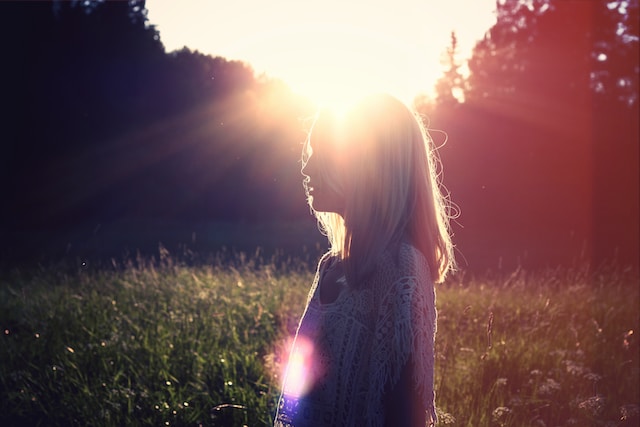 woman in a field at sunrise