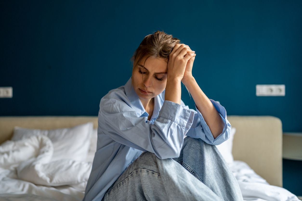 woman in pain on her bed