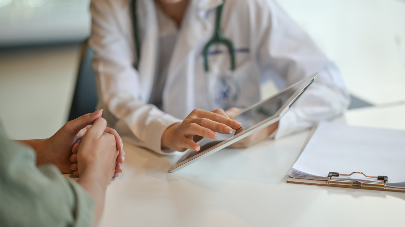 doctor showing patient results on a tablet