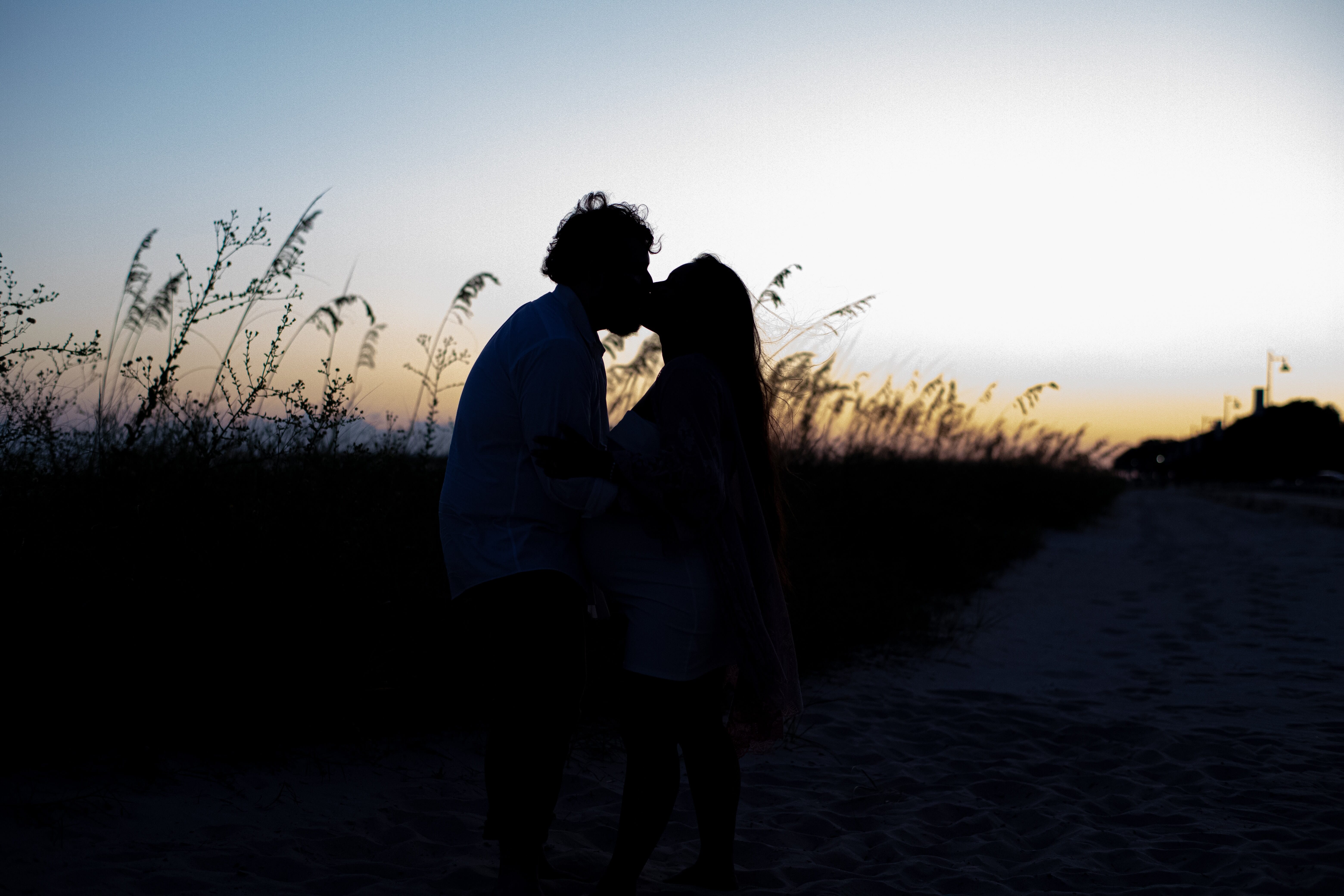 couple kissing at sunset