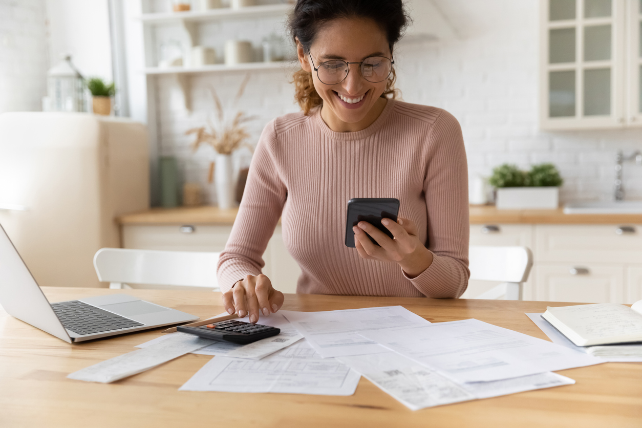 woman smiling at her mobile phone