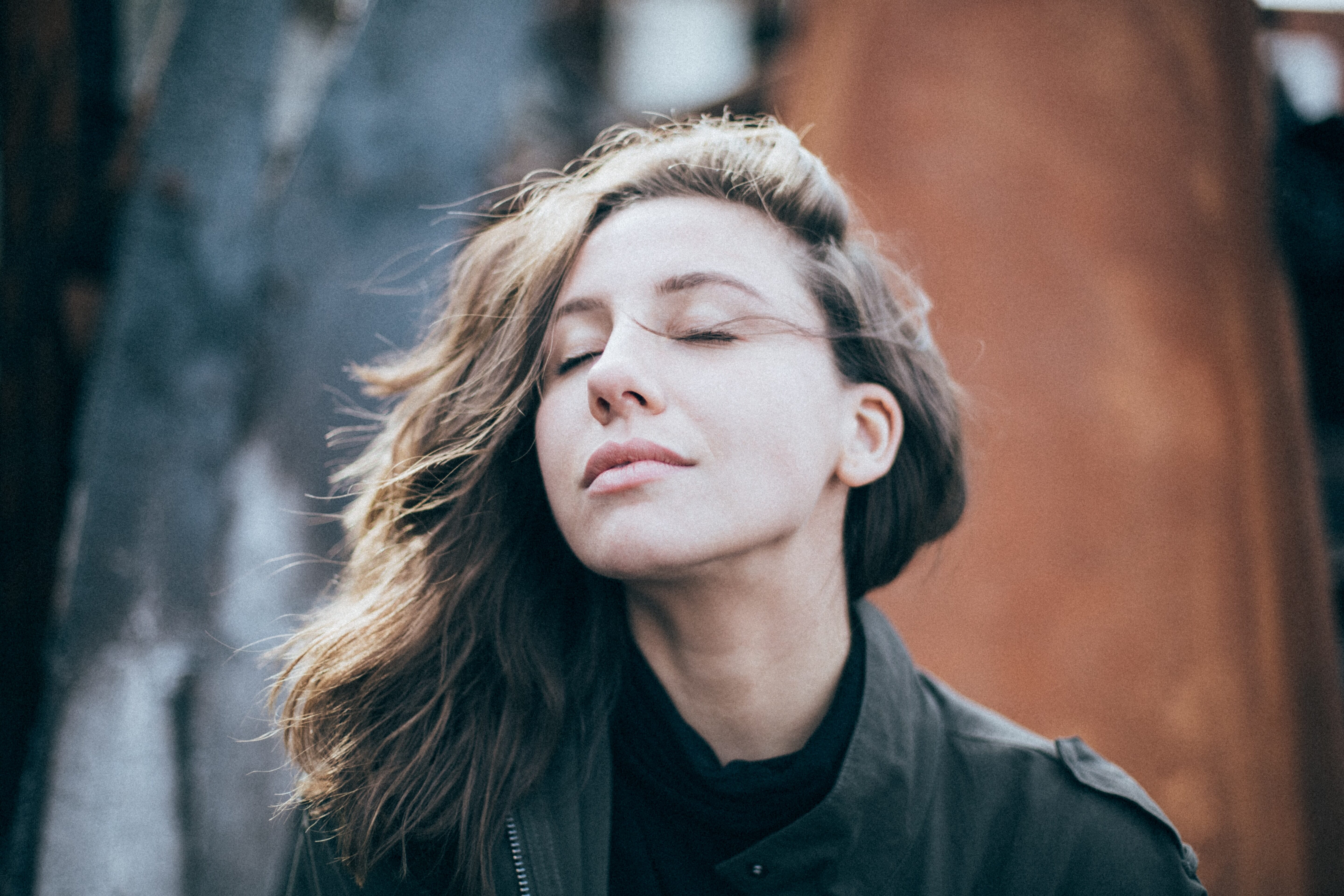 calm woman eyes closed wind in her hair