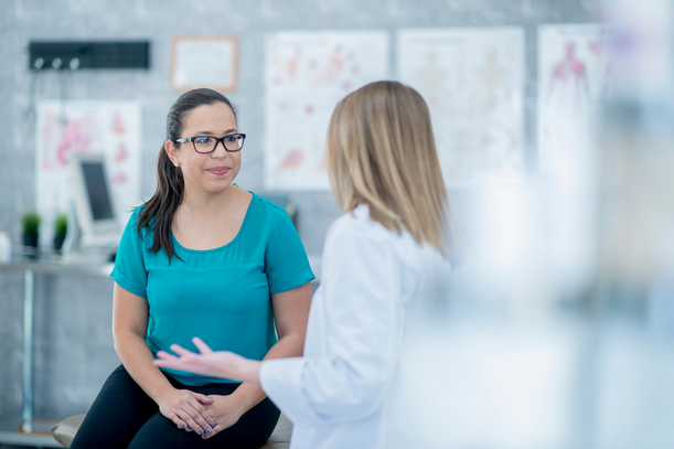 doctor consulting with woman over 35