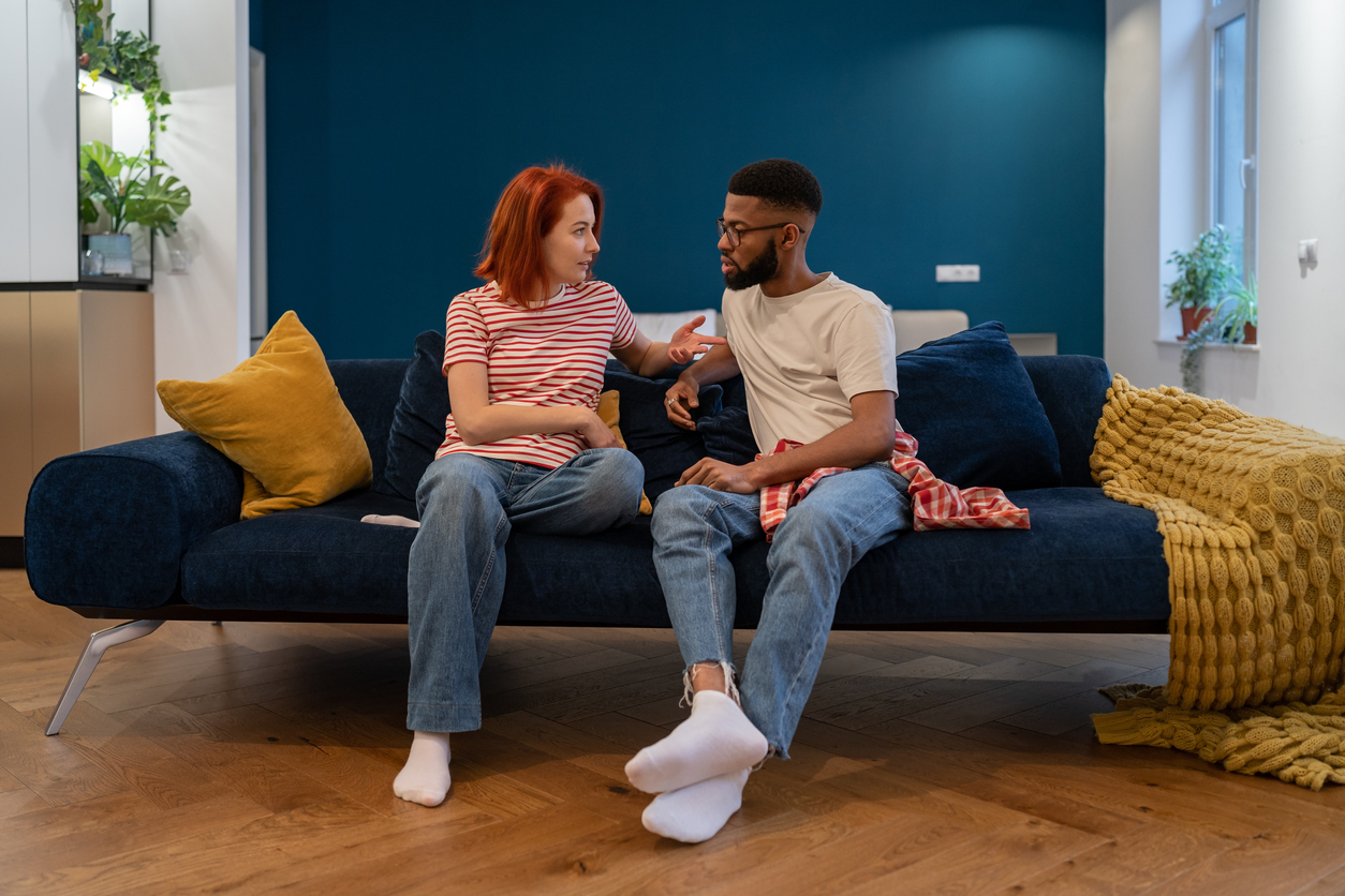 couple talking on a sofa