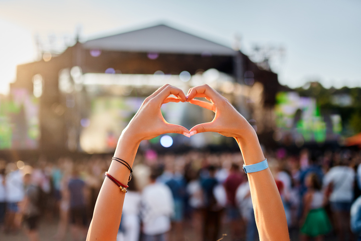 woman making a heart symbol with her hands