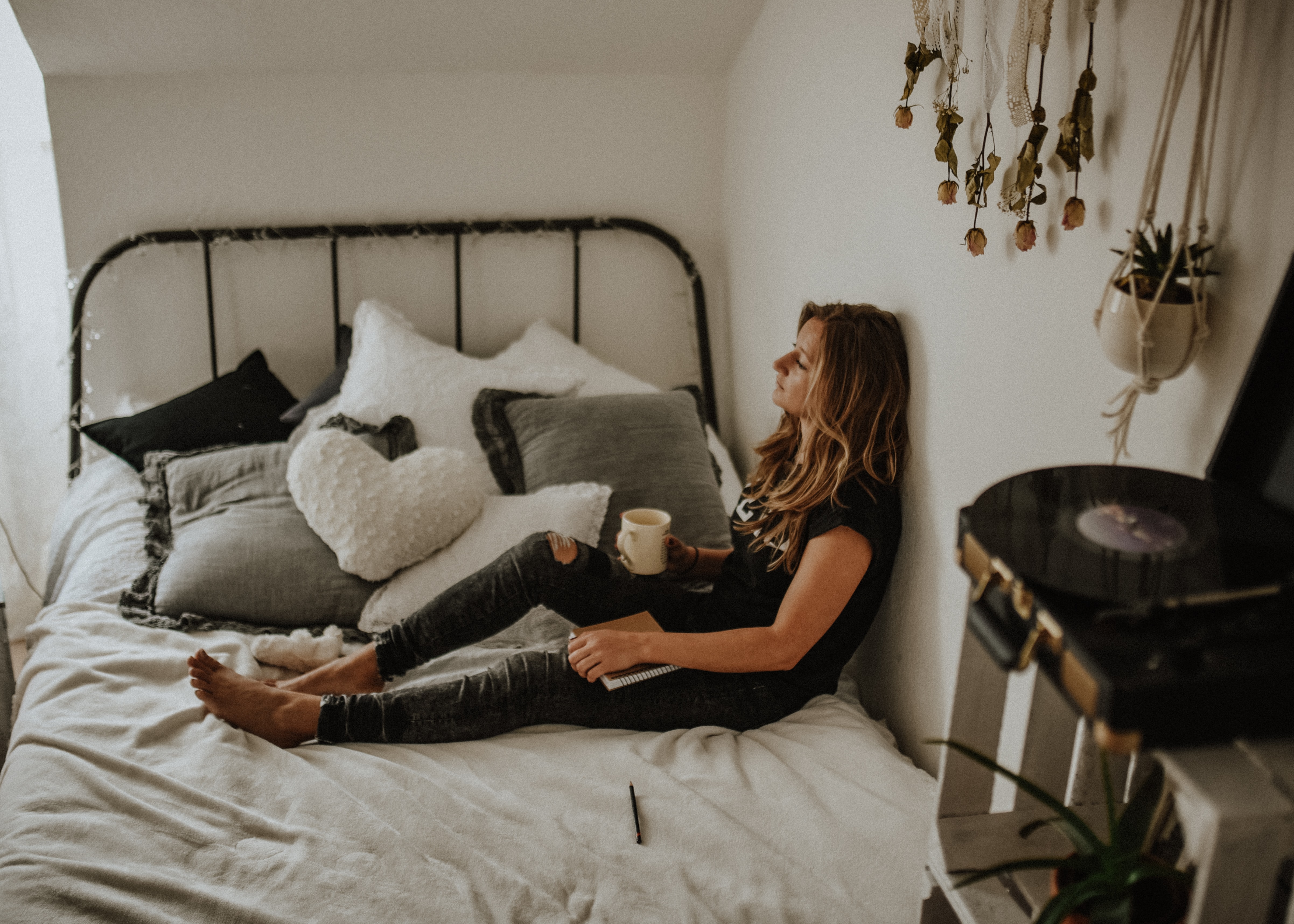 woman journaling in her bedroom