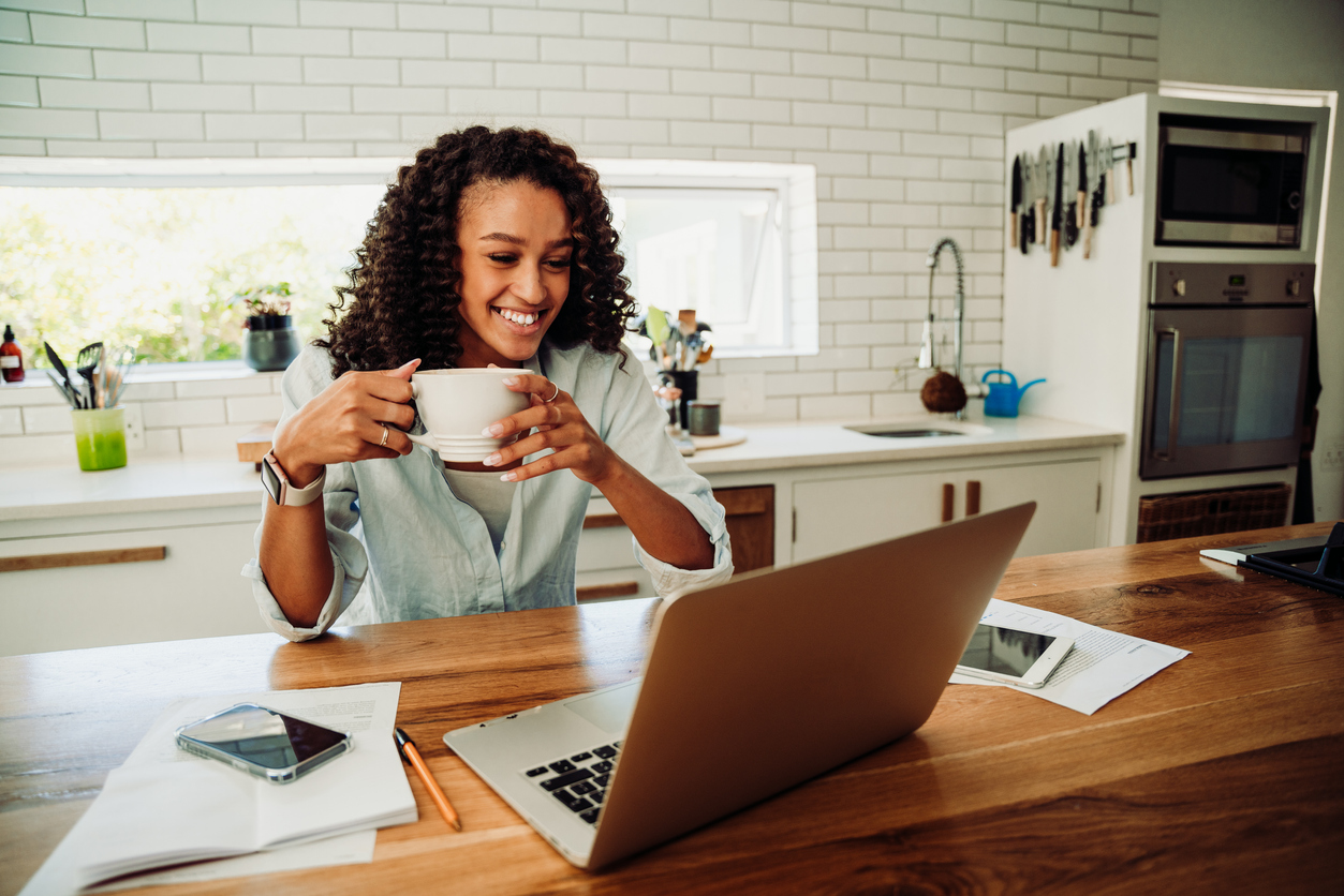 woman drinking coffee and researching how to pay for egg freezing