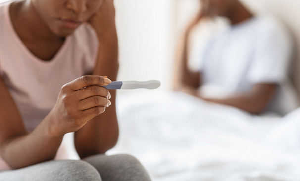 woman looking at the results of a pregnancy test