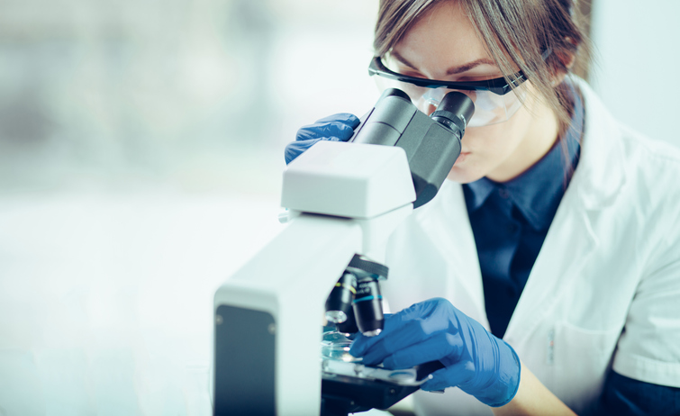 lab technician examining a pgt-a test sample