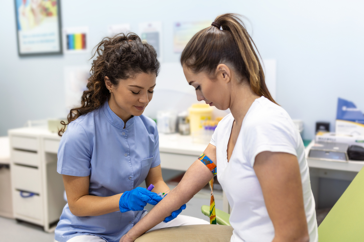 medical assistant taking blood from a patient