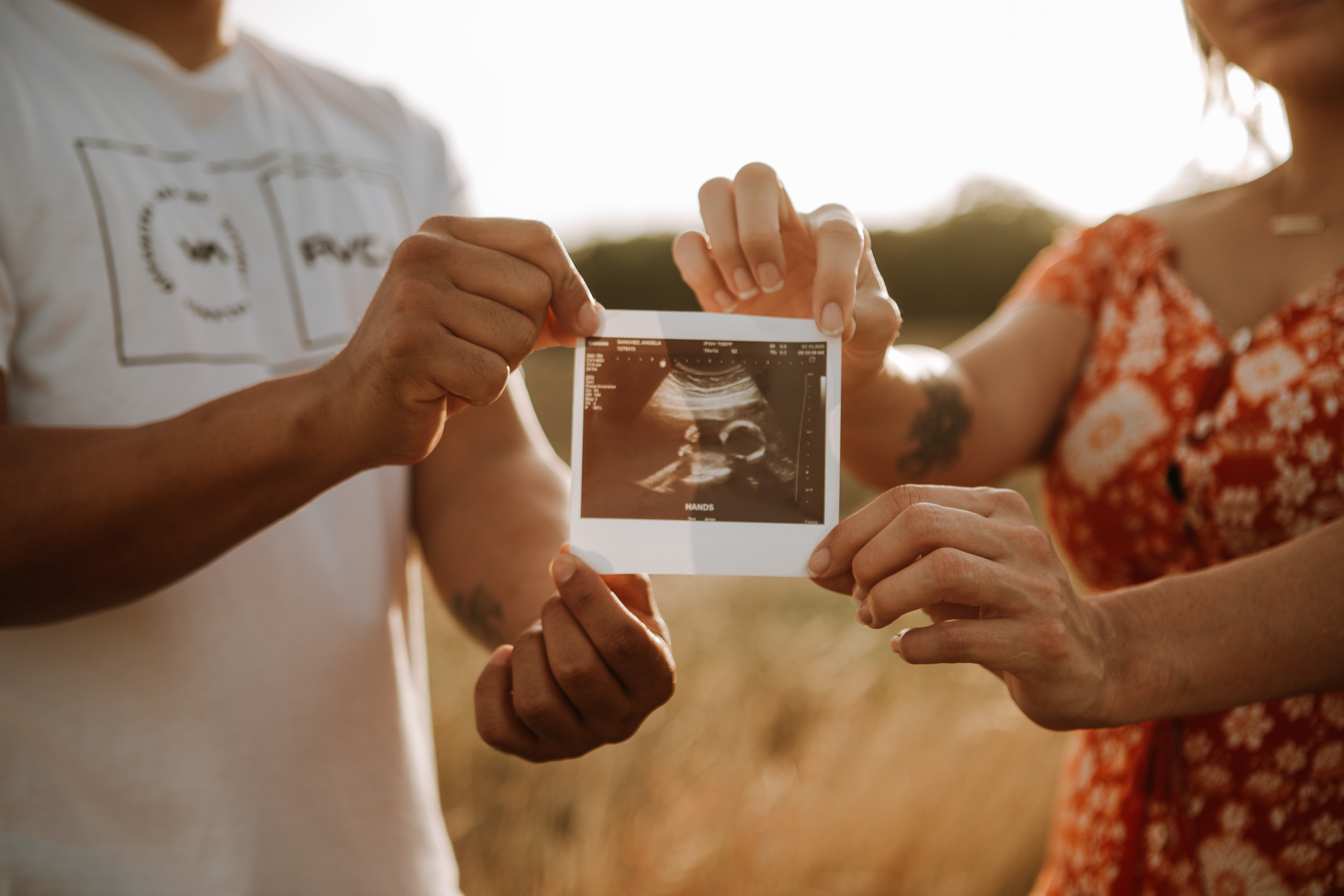 couple holding their ultrasound photo