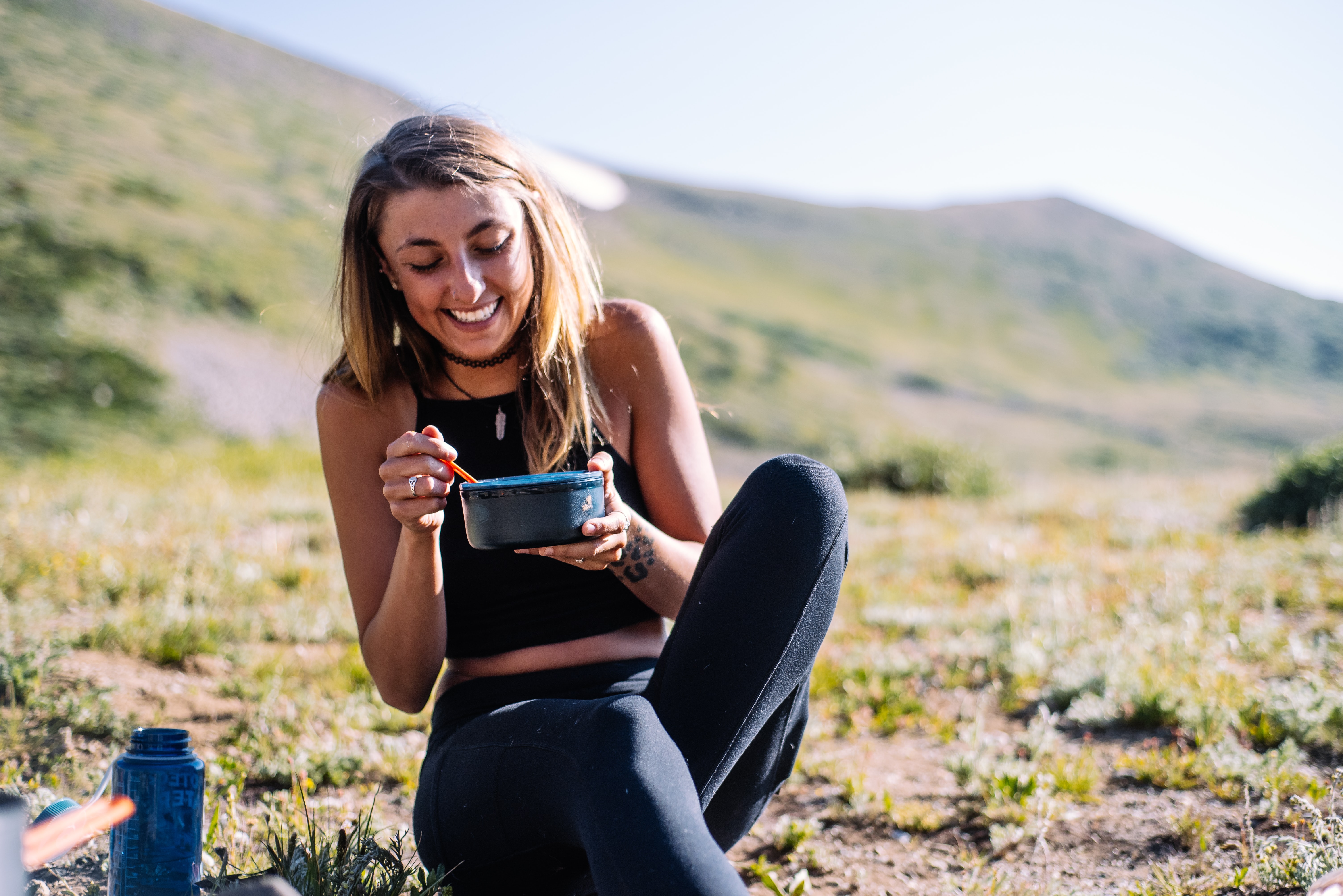 woman eating a meal in the great outdoors