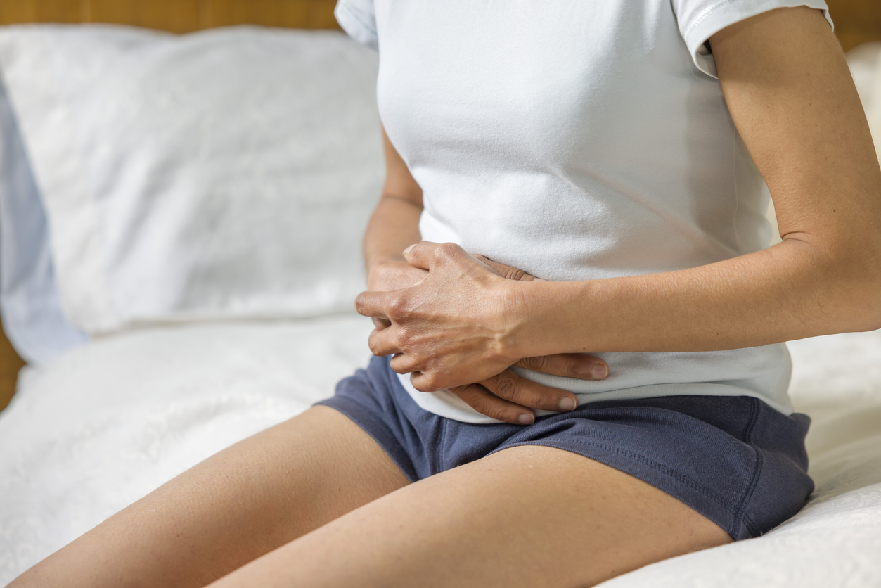 woman holding her abdomen in pain