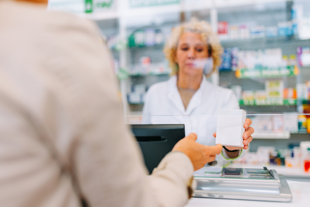 woman picking up iron supplements at the pharmacy