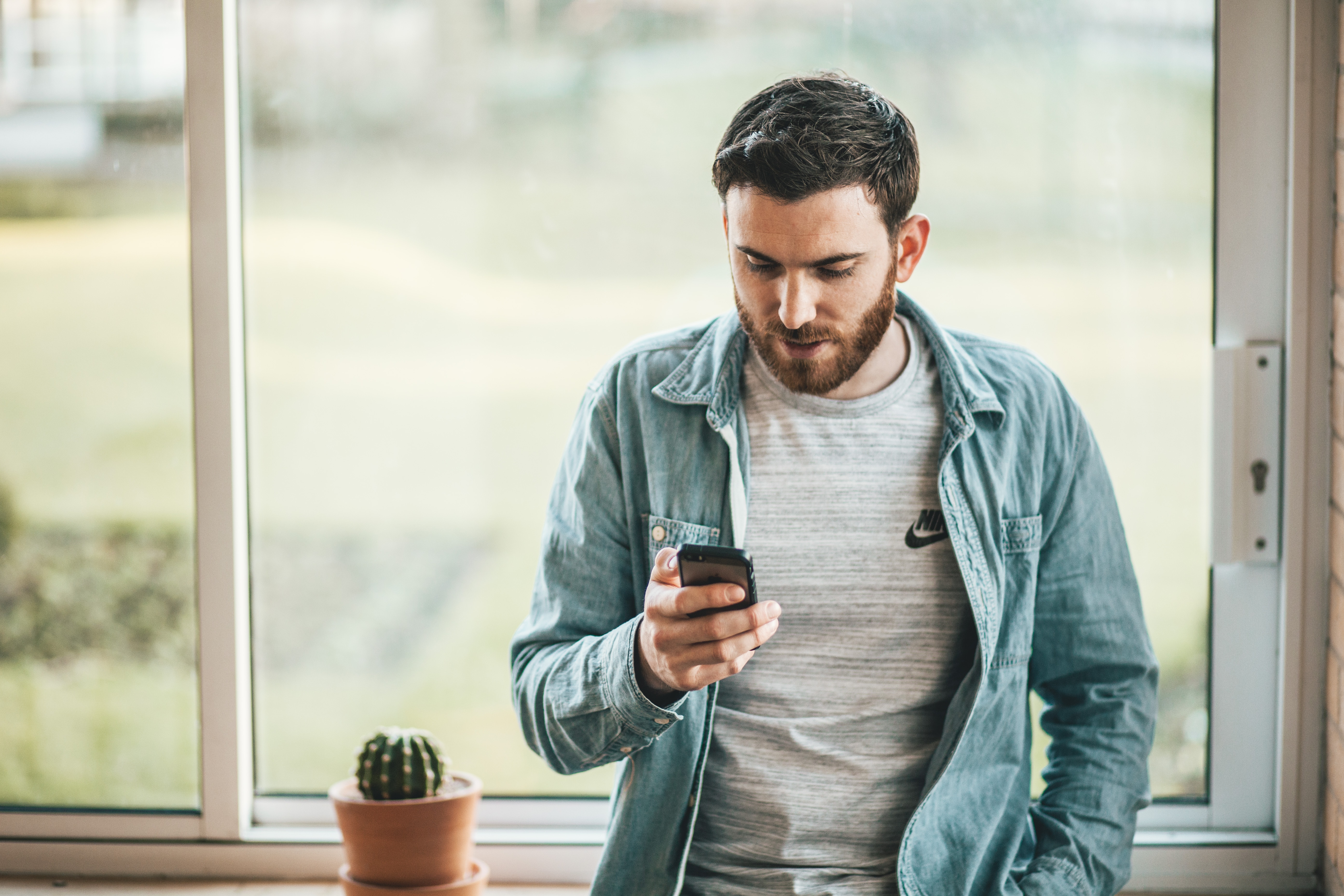 man reading a text on mobile phone