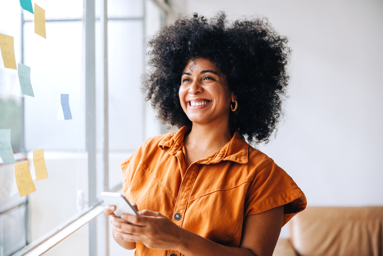 smiling woman reading post-it notes