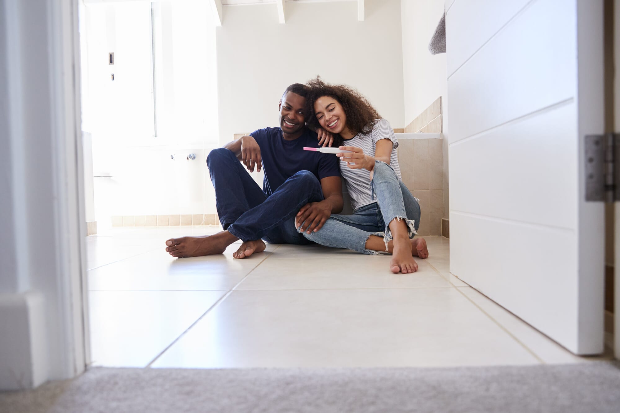 happy couple with positive pregnancy test