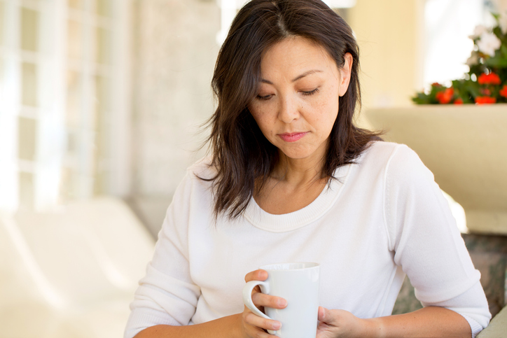 pensive woman drinking tea