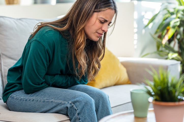 woman doubled over in pain from menstrual cramps