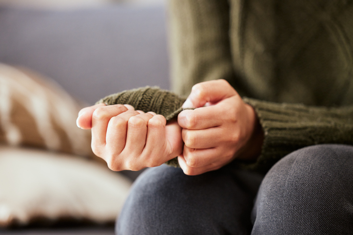 anxious woman fidgeting with her shirt sleeves