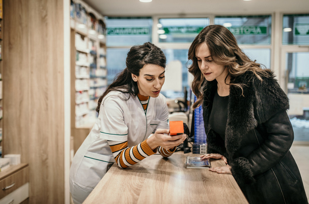 pharmacist giving medicine directions to a patient