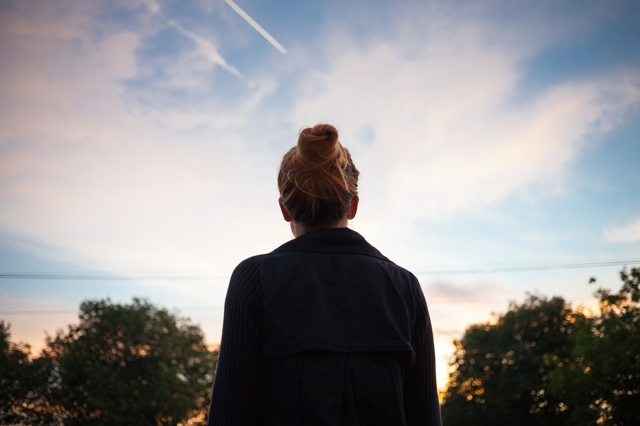 woman outside enjoying sunrise