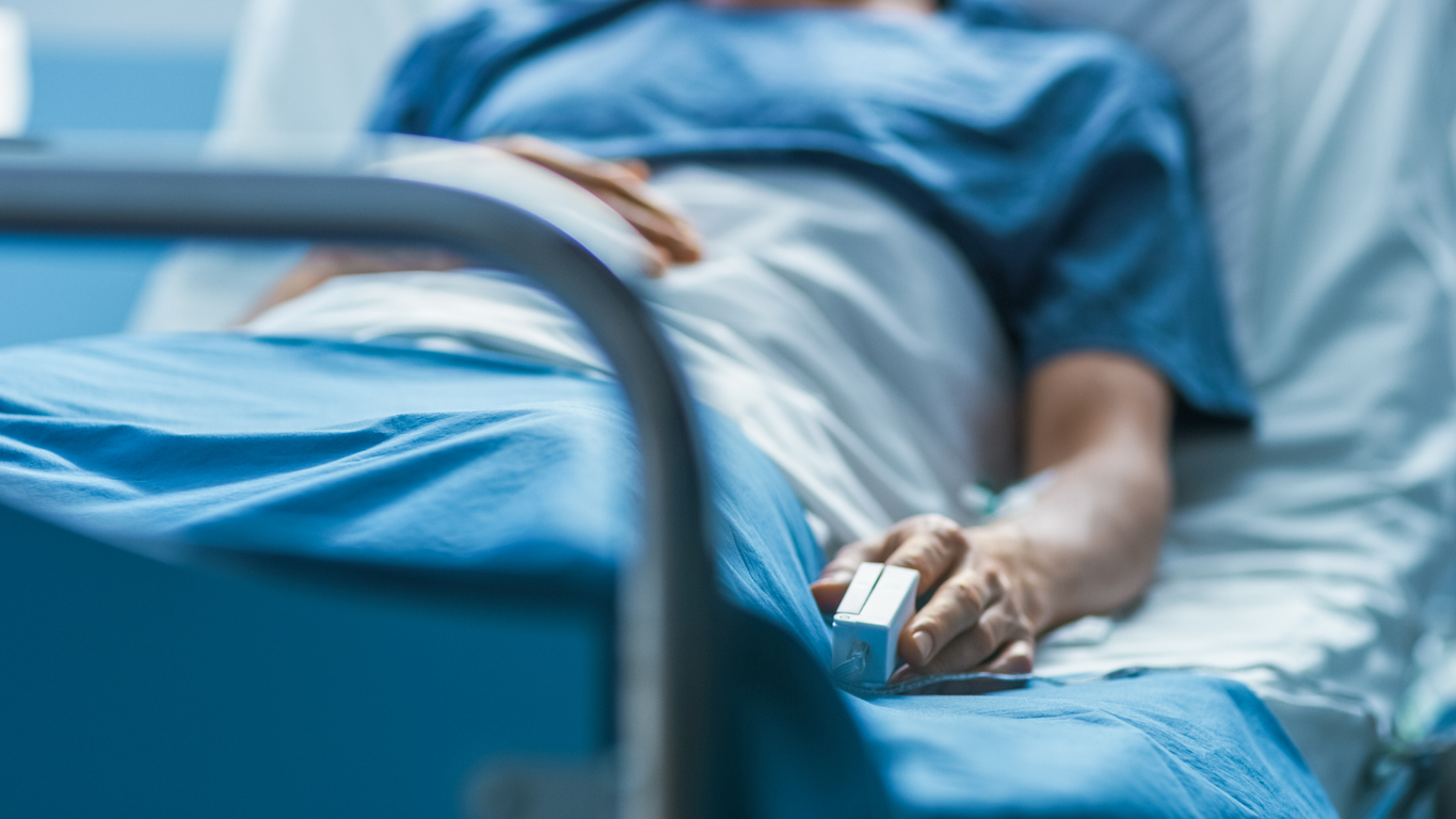 woman in a hospital bed pre abdominal surgery