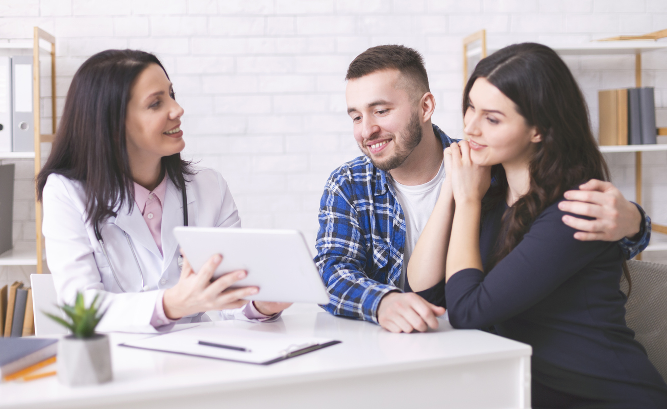 couple meeting with an infertility specialist to discuss fertility clinic success rates