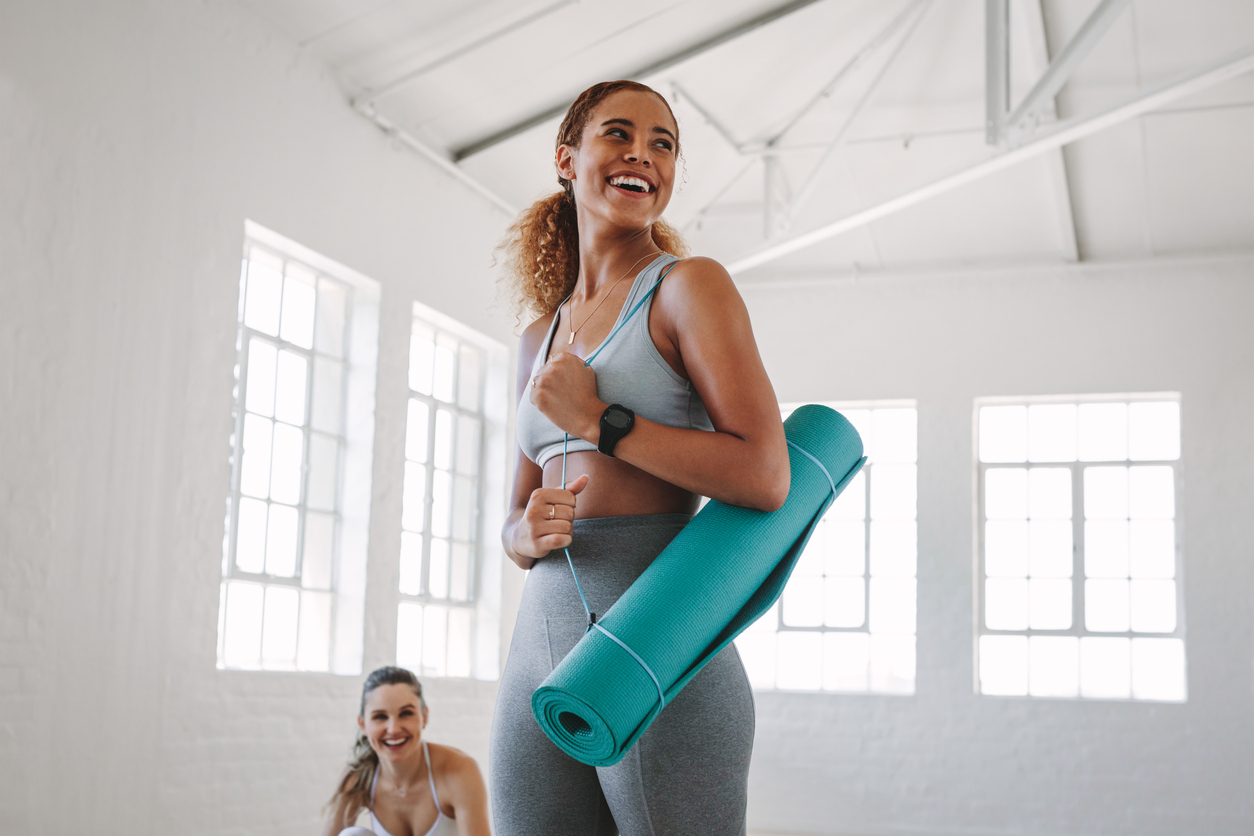 woman carrying a yoga mat