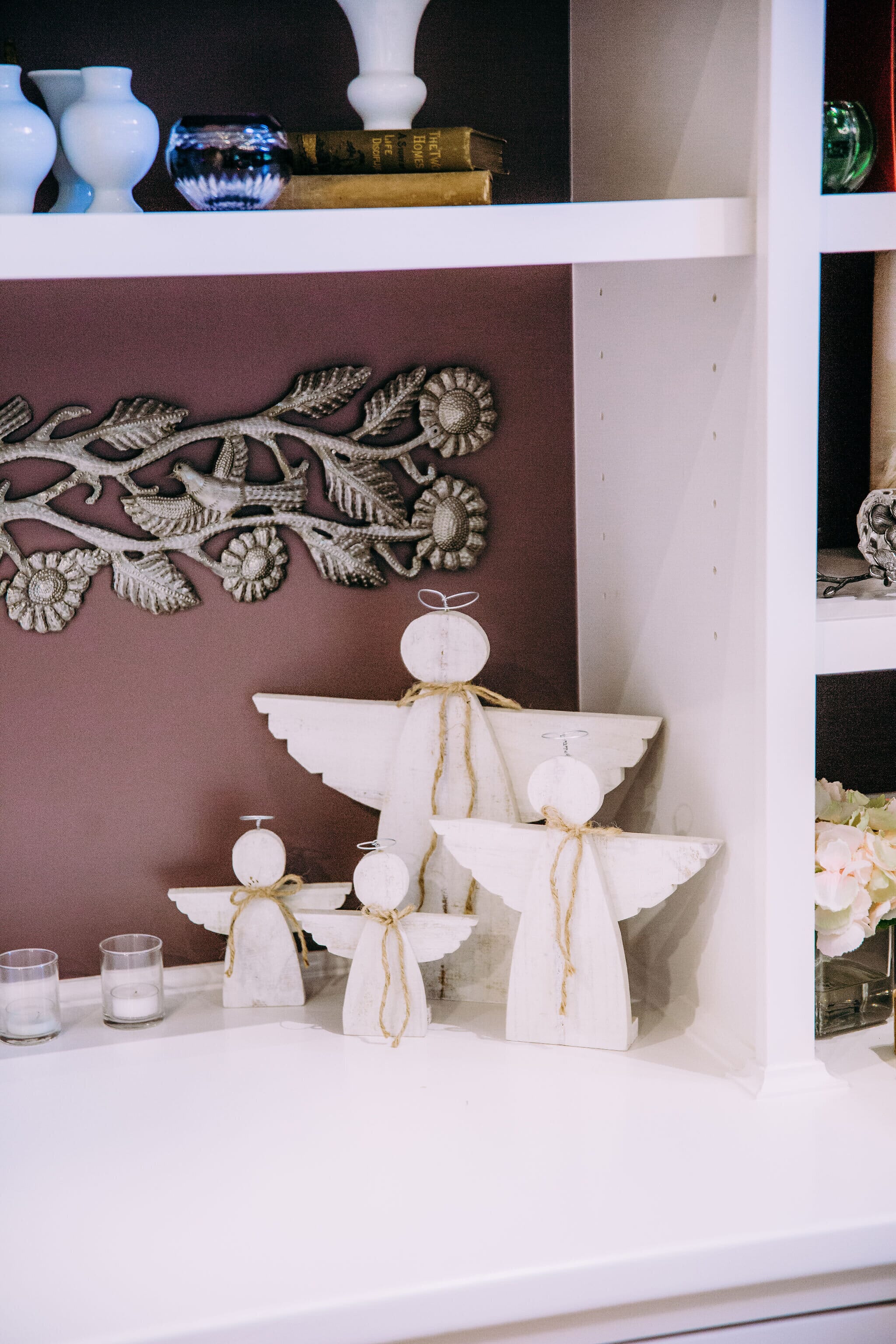 four wooden angels on a mantle