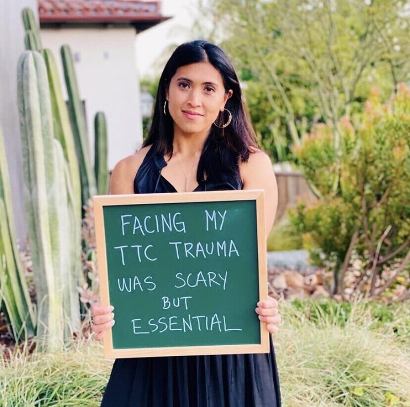 josephine alturi holding a sign that reads "facing my ttc trauma was scary but essential"