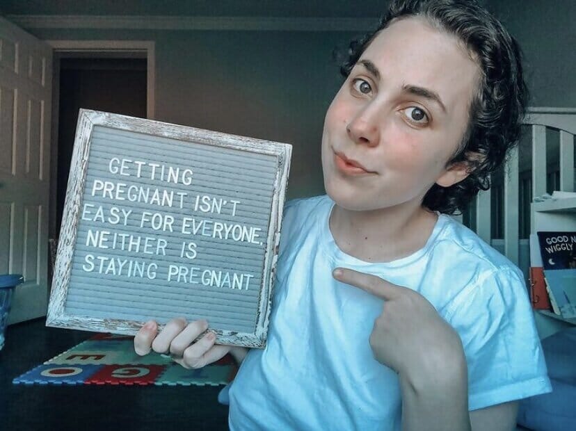 infertility warrior arden cartrette holding a sign that reads &quot;getting pregnant is easy for everyone, neither is staying pregnant&quot;