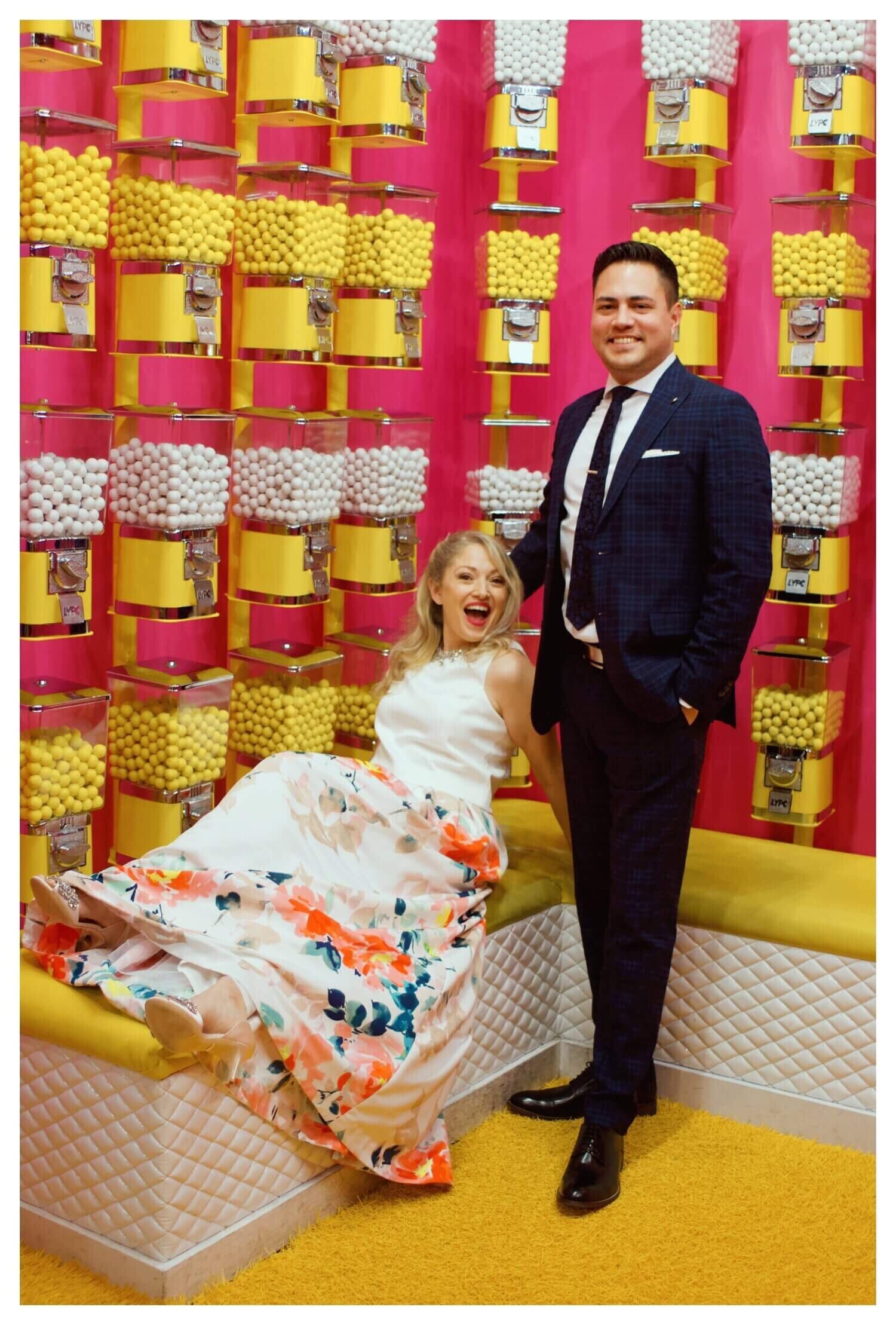 alexandra slate and her husband surrounded by gobs of gumball machines