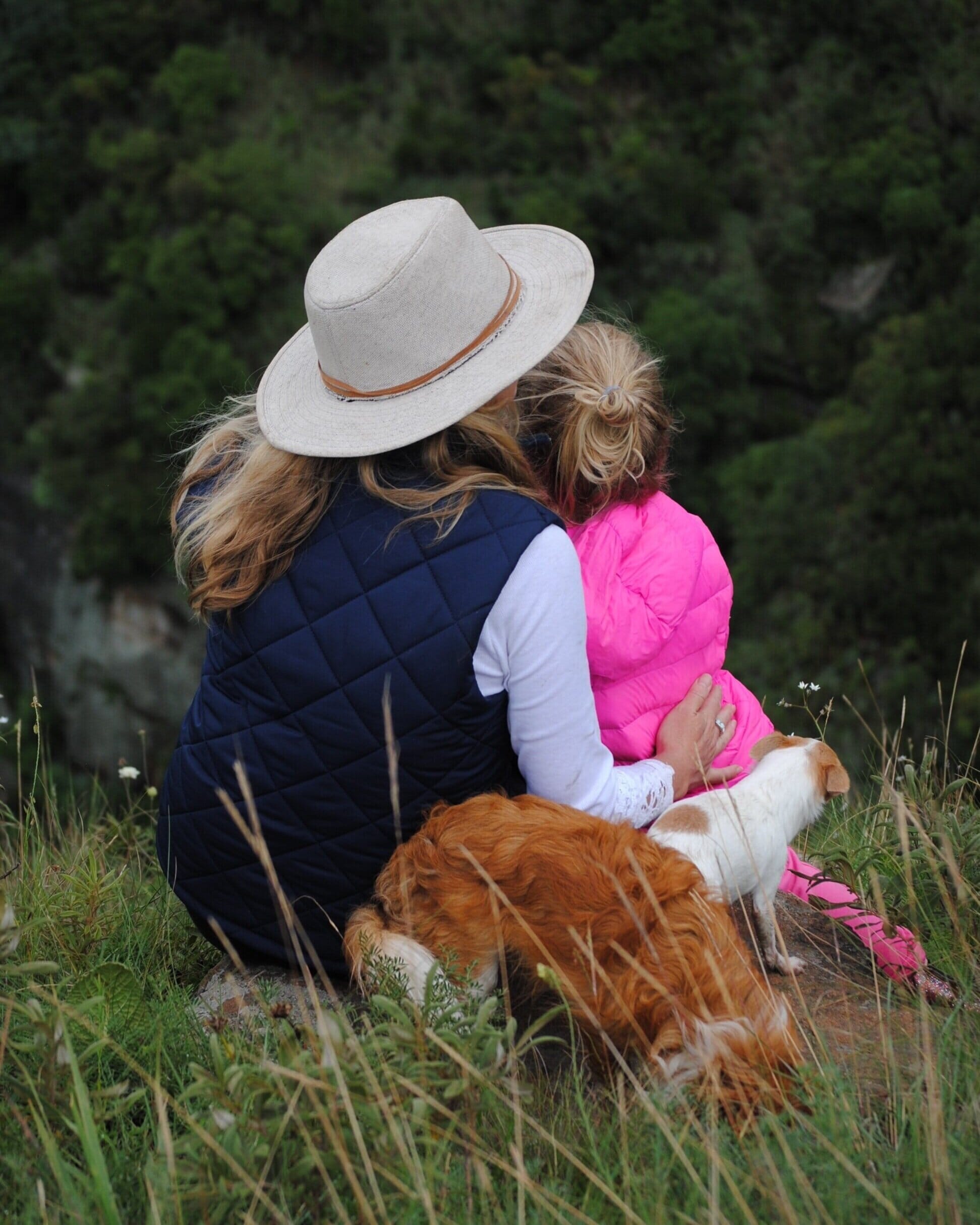 woman and child sitting in the woods together