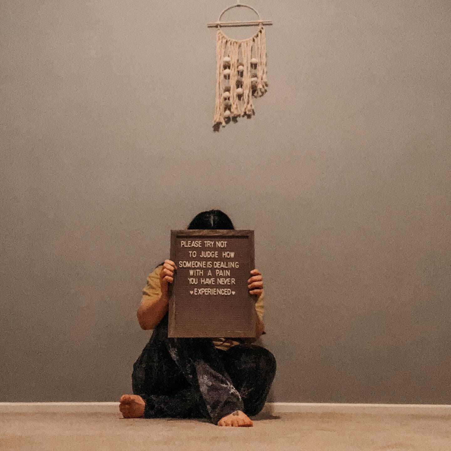 woman holding a sign asking for understanding