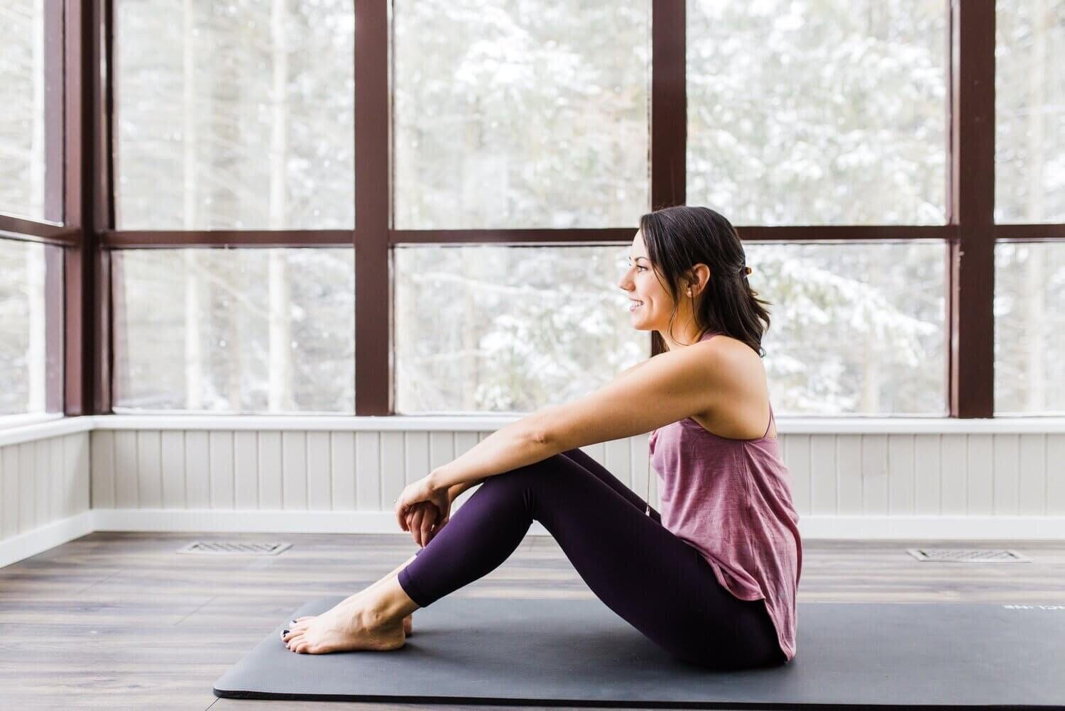 jessica dalliday sitting on a yoga mat