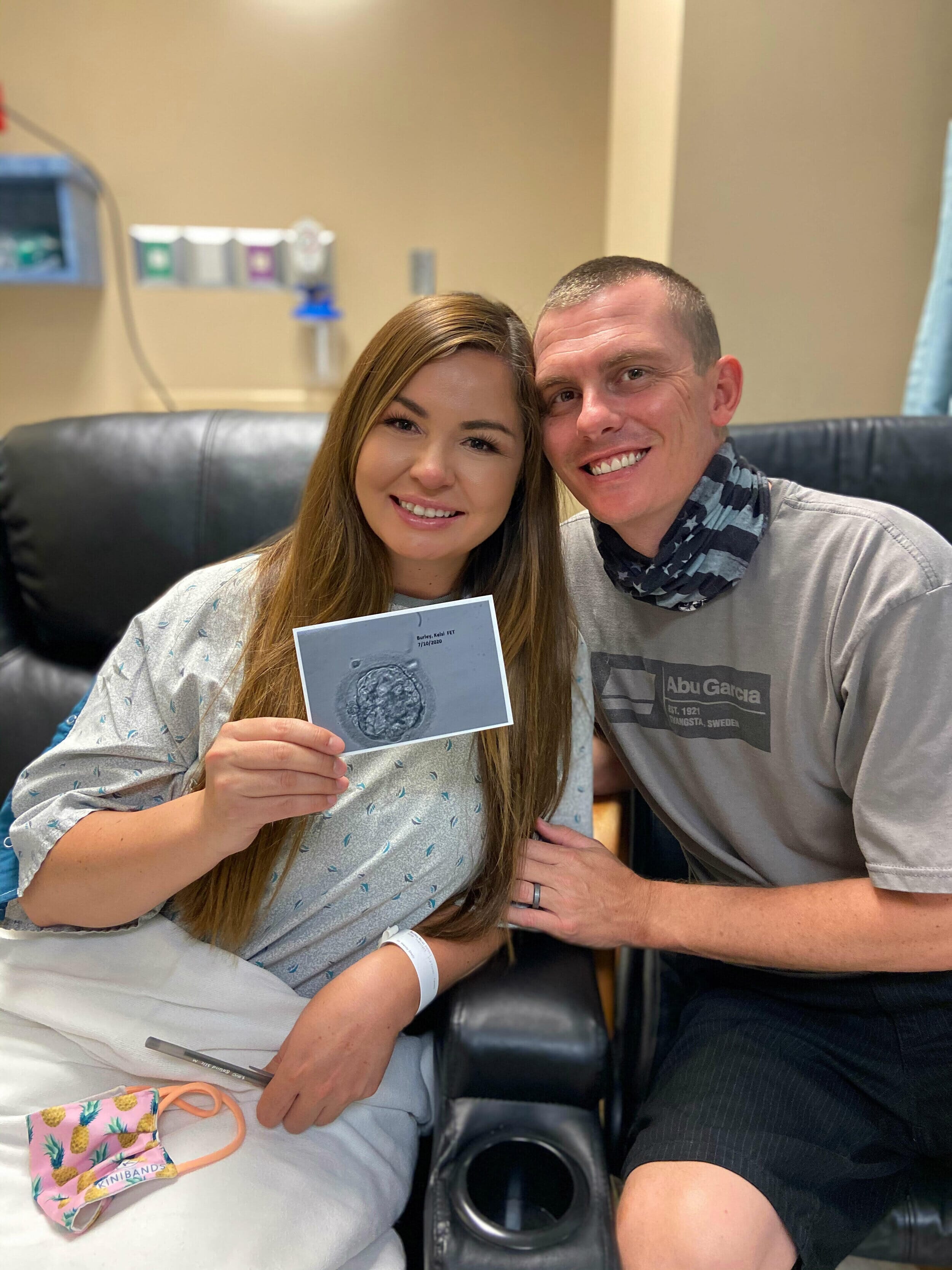 kelsi burley with husband holding a blastocyst embryo photo