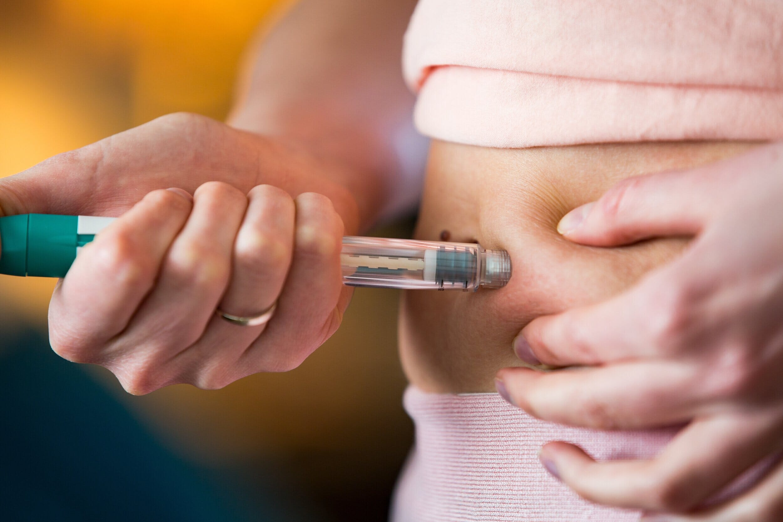 woman giving herself an ivf trigger shot