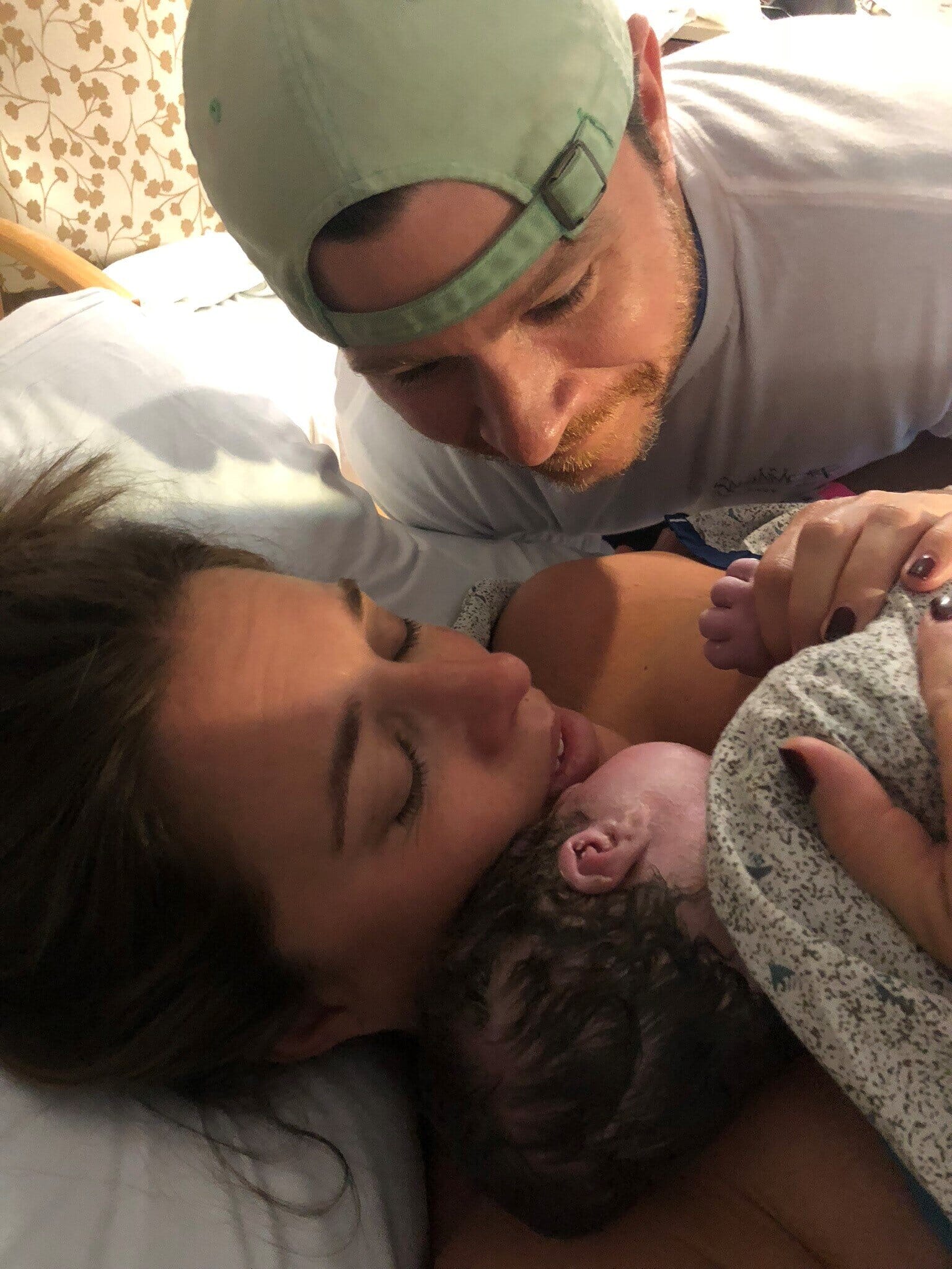 brett russo and her husband with their newborn