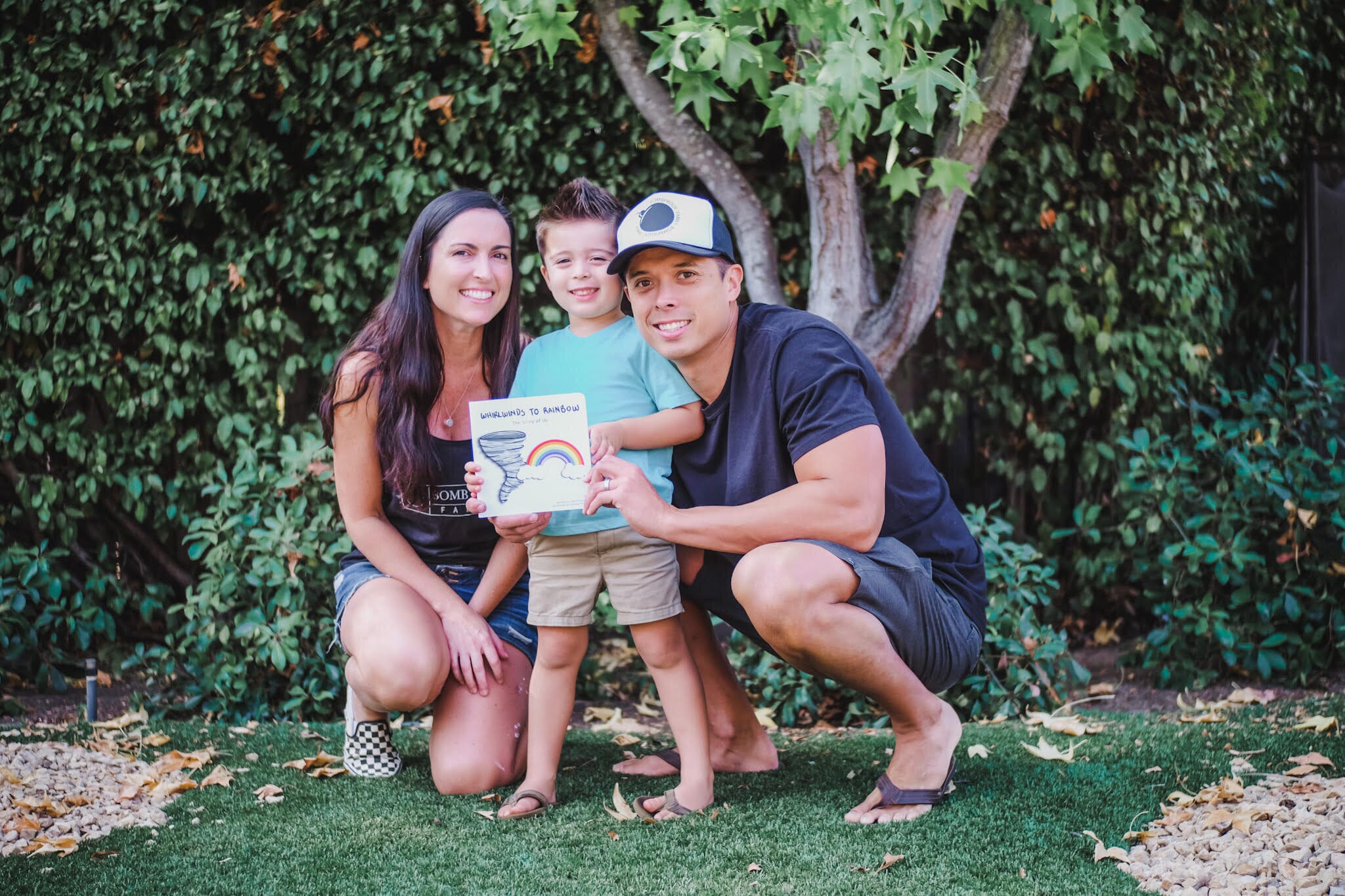 kimberly morrison and her family holding children's book whirlwinds to rainbow