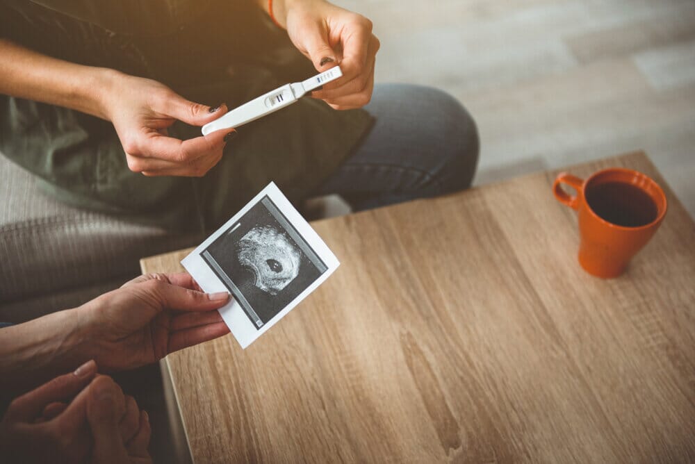 positive pregnancy test and ultrasound photo