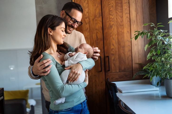 couple delighting in their new baby