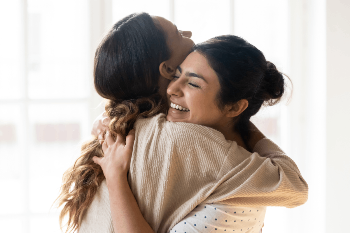 woman celebrating her pregnancy with a friend