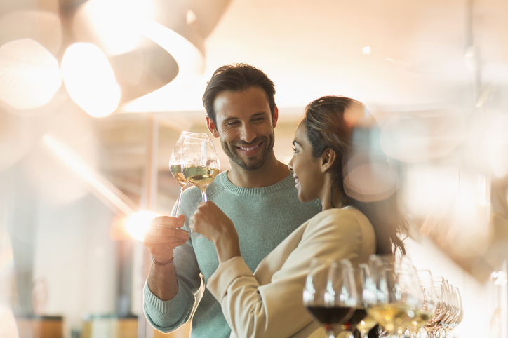 couple clinking wine glasses at a party