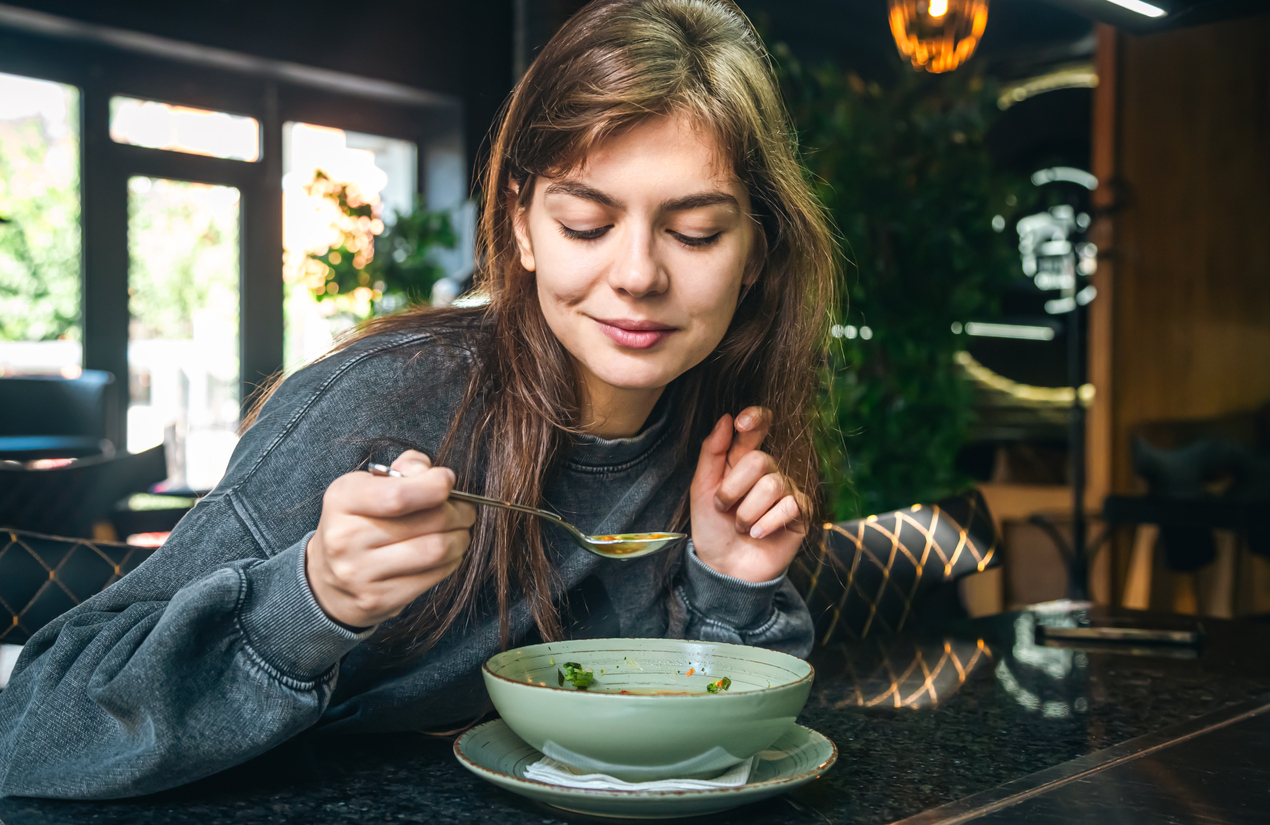 woman eating soup